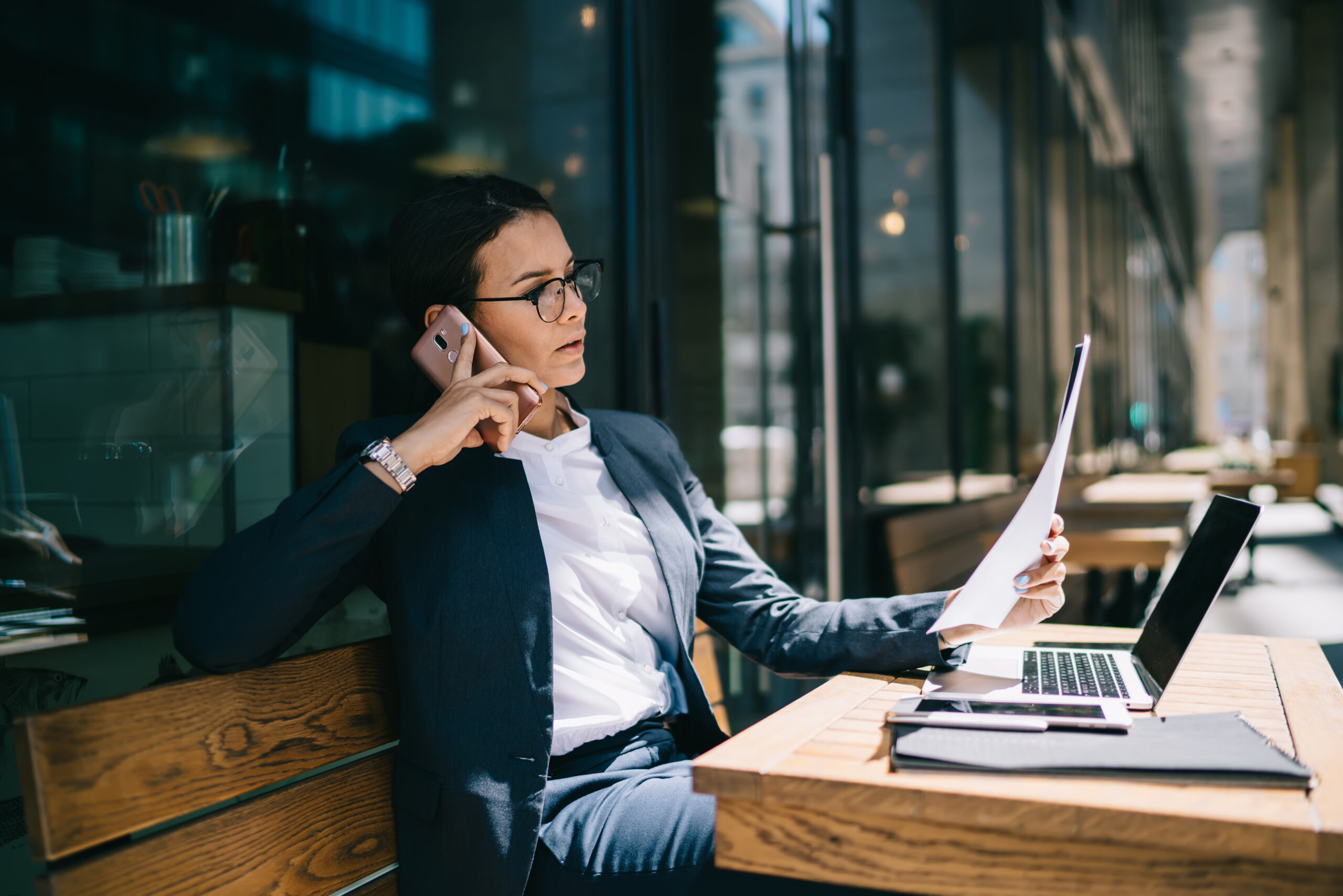 Busy female calling on mobile phone during remote work